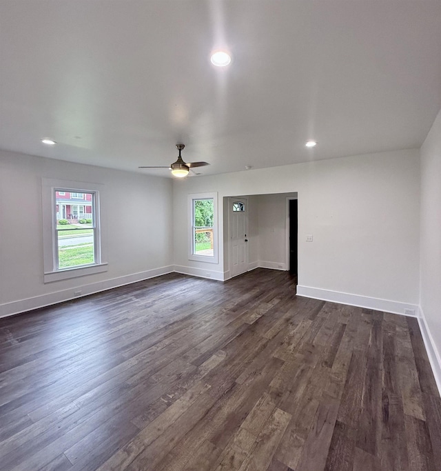 empty room featuring dark wood-style floors, baseboards, a ceiling fan, and recessed lighting