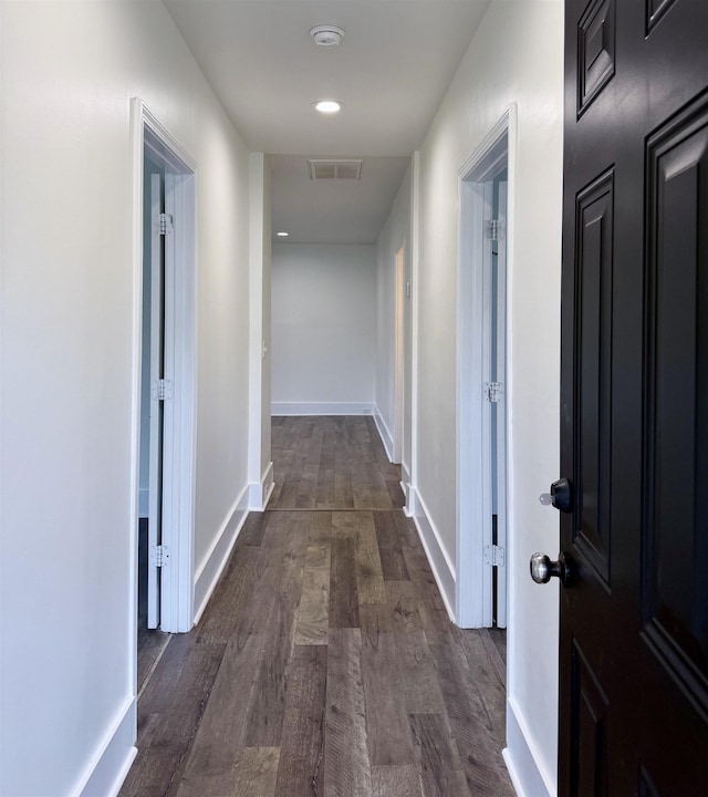 hall with baseboards, recessed lighting, visible vents, and dark wood-type flooring