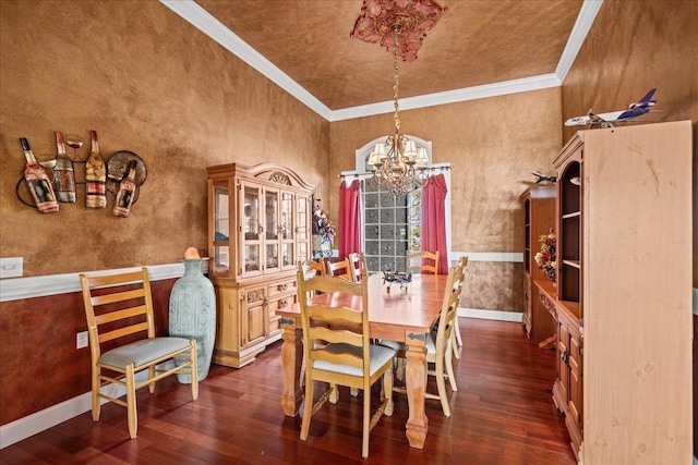 dining room with wood-type flooring, ornamental molding, a chandelier, and baseboards