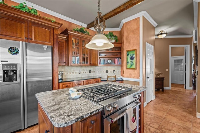 kitchen featuring a center island, stainless steel appliances, brown cabinetry, and backsplash
