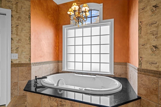 full bath featuring a notable chandelier and a bath