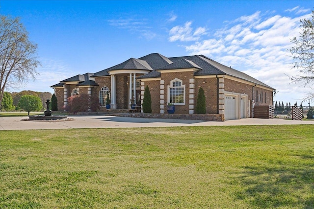 view of front facade featuring driveway, an attached garage, a front yard, and brick siding