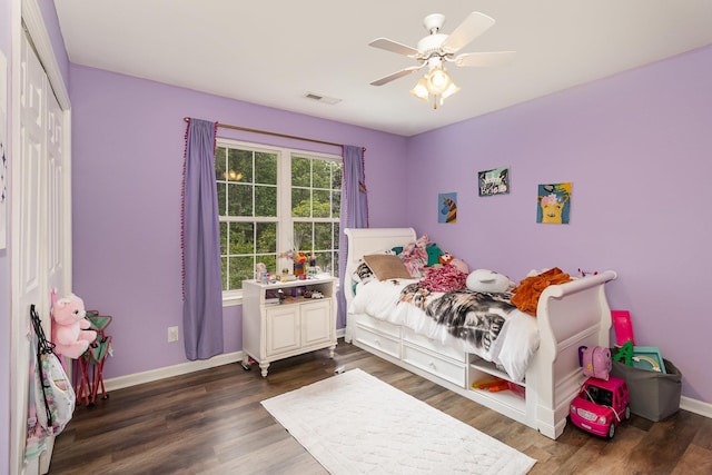 bedroom with visible vents, ceiling fan, dark wood finished floors, and baseboards
