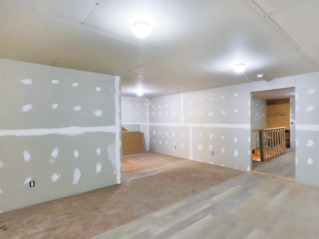 finished below grade area featuring wood finished floors