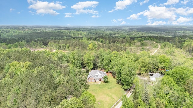aerial view featuring a wooded view