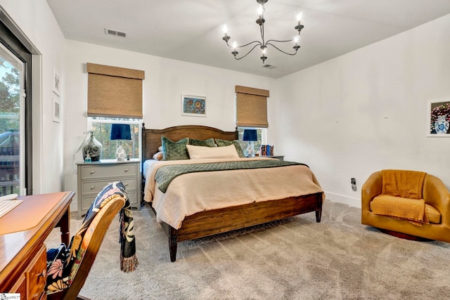 carpeted bedroom featuring baseboards, visible vents, and a notable chandelier