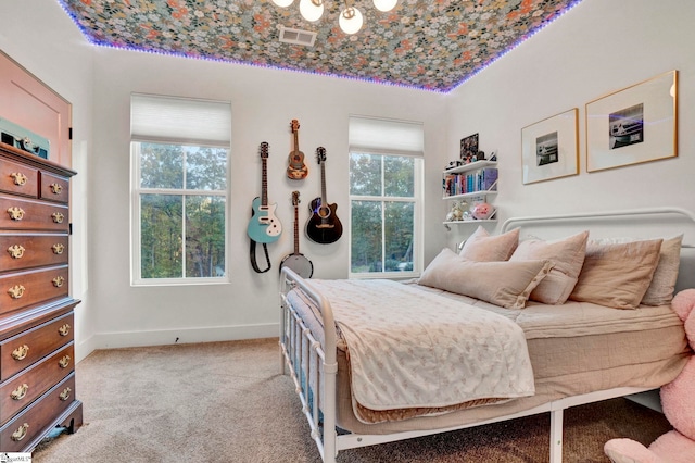 carpeted bedroom featuring visible vents and baseboards