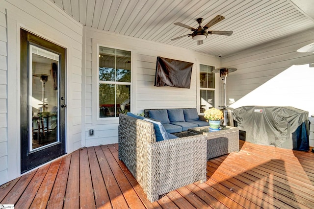 wooden terrace featuring an outdoor living space and a ceiling fan