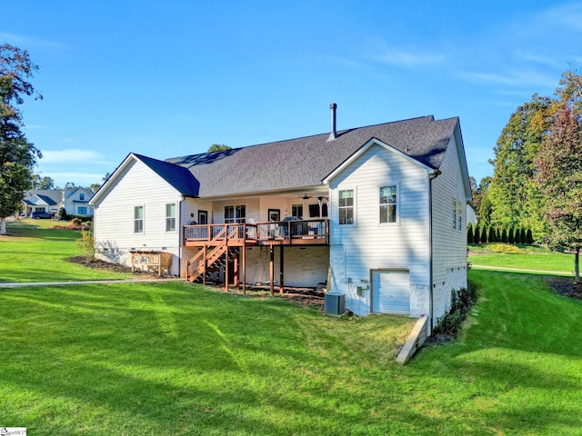 back of property featuring stairs, a garage, a wooden deck, a ceiling fan, and a lawn