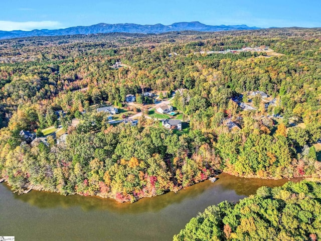 bird's eye view with a water and mountain view and a wooded view