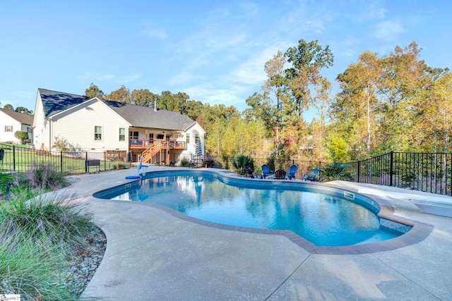 view of pool featuring a deck, a fenced in pool, a fenced backyard, and a patio area