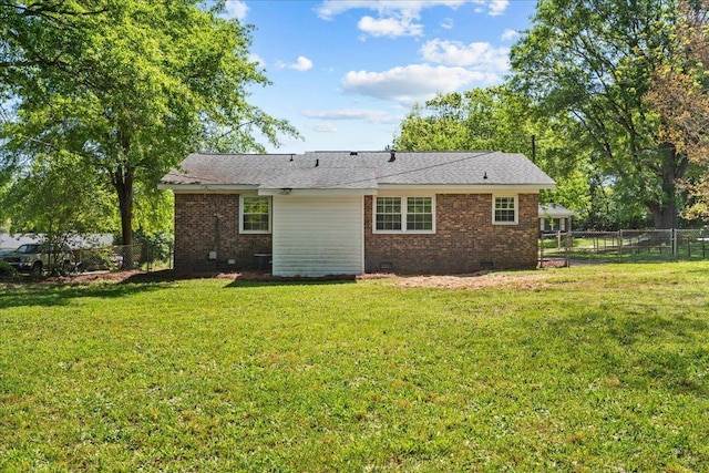 back of house with a yard, crawl space, brick siding, and a fenced backyard