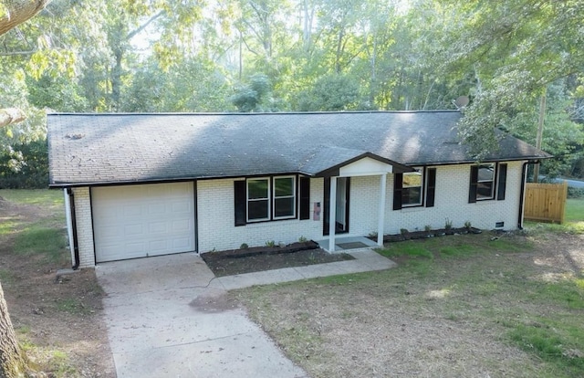 ranch-style house featuring concrete driveway, roof with shingles, a garage, and brick siding