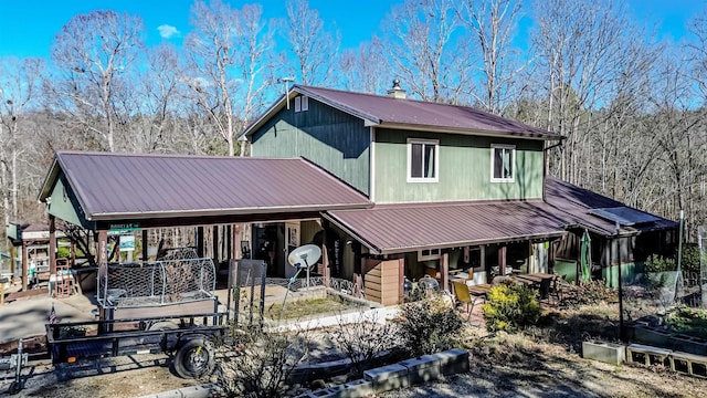 back of property featuring metal roof and covered porch