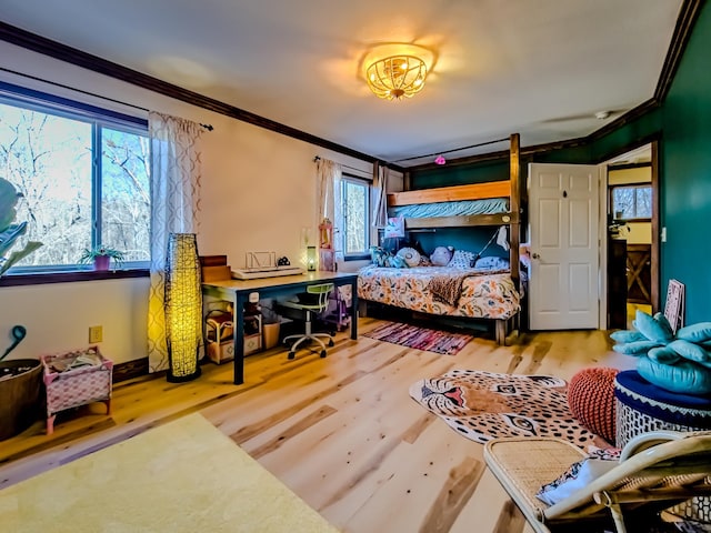bedroom featuring crown molding and wood finished floors