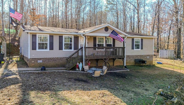 view of front of property with crawl space, stairway, and covered porch