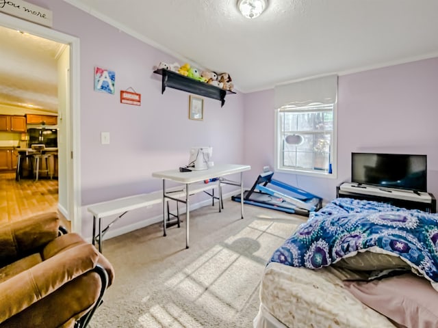 bedroom with light carpet, ornamental molding, and baseboards