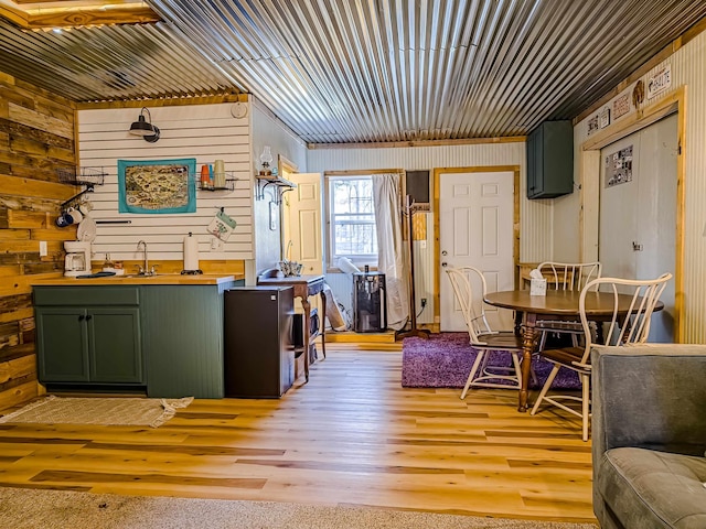interior space with wood walls and light wood-type flooring