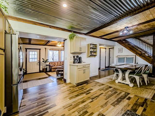 kitchen with wooden ceiling, light wood-type flooring, baseboards, light countertops, and freestanding refrigerator