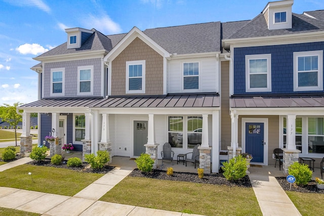 173 Dalmatian, Spartanburg, SC 29307 - townhome / multi-family property with covered porch, a standing seam roof, a front lawn, and roof with shingles