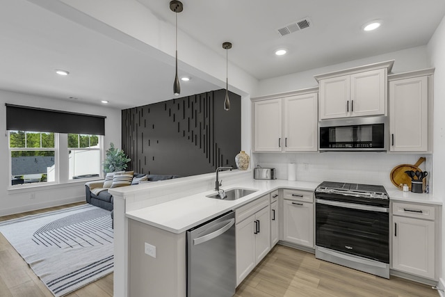173 Dalmatian, Spartanburg, SC 29307 - kitchen with a sink, appliances with stainless steel finishes, visible vents, light countertops, and open floor plan