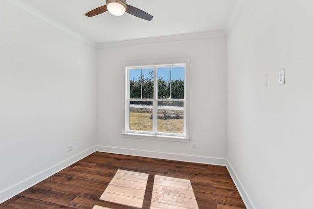empty room with ornamental molding, ceiling fan, wood finished floors, and baseboards