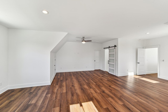 bonus room with a barn door, wood finished floors, a ceiling fan, and recessed lighting
