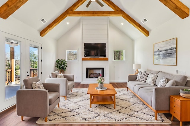 living room featuring visible vents and beam ceiling