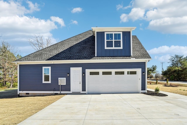 view of front of house with roof with shingles, concrete driveway, a front yard, and board and batten siding