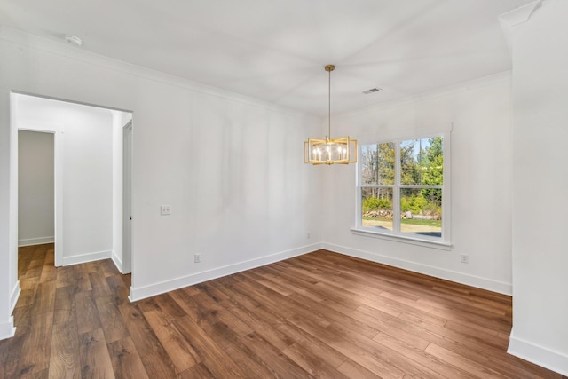 unfurnished dining area featuring dark wood-type flooring, baseboards, visible vents, a notable chandelier, and crown molding