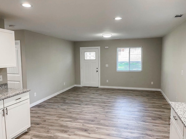 interior space with recessed lighting, baseboards, light wood finished floors, and visible vents