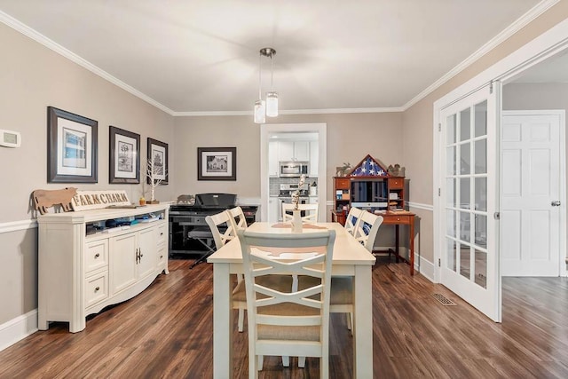 dining space featuring baseboards, ornamental molding, and dark wood-type flooring