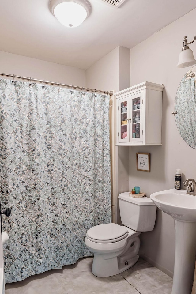 full bath with toilet, tile patterned floors, and a shower with shower curtain