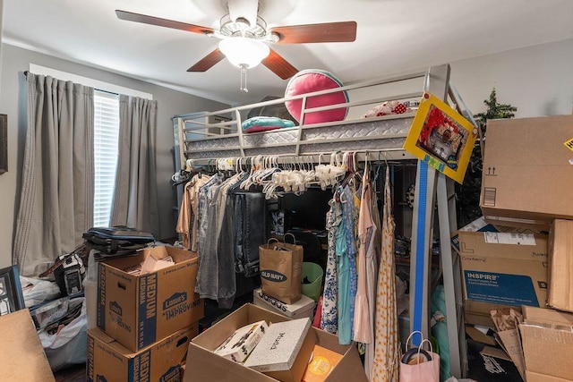 walk in closet featuring a ceiling fan