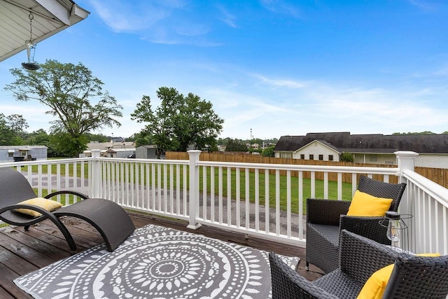 wooden terrace with a lawn