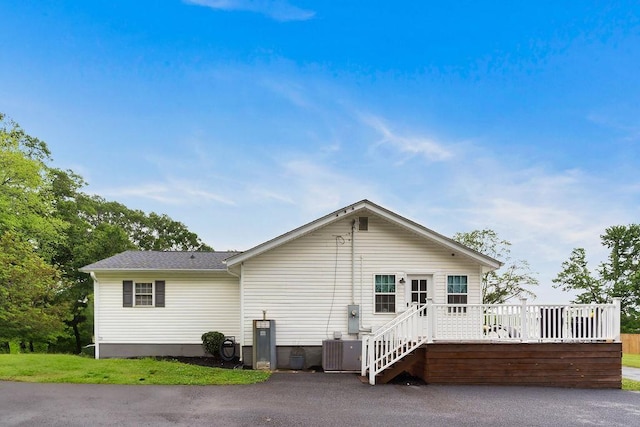 back of property featuring cooling unit and a deck