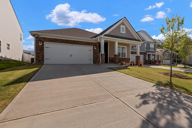 craftsman-style house featuring roof with shingles, an attached garage, a porch, a front yard, and concrete driveway