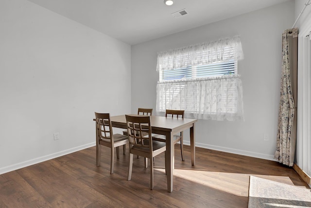 dining room with baseboards, wood finished floors, and visible vents