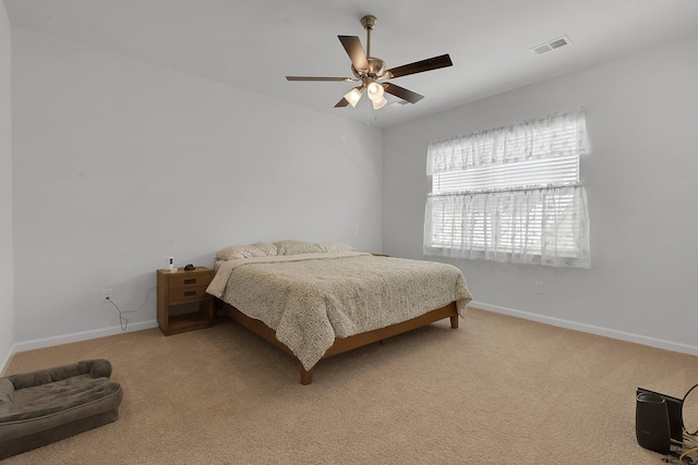 bedroom featuring baseboards, visible vents, ceiling fan, and carpet