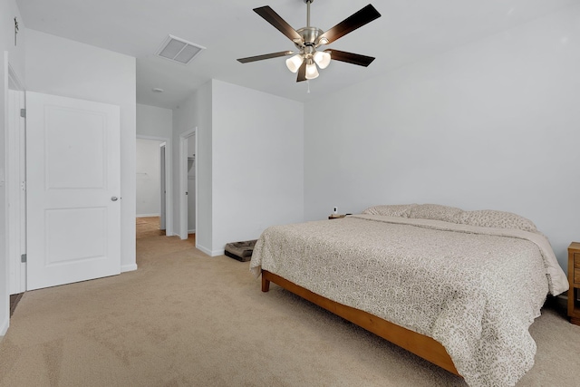 bedroom featuring visible vents, baseboards, ceiling fan, and light carpet