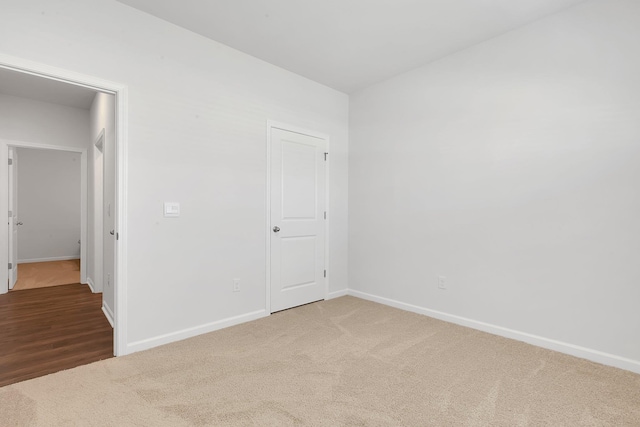 unfurnished bedroom featuring carpet floors and baseboards