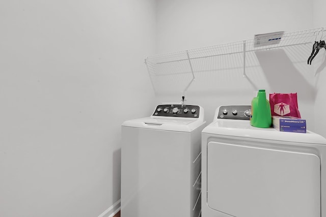 washroom with separate washer and dryer and laundry area