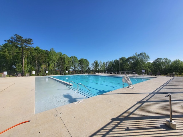 pool featuring a patio and fence