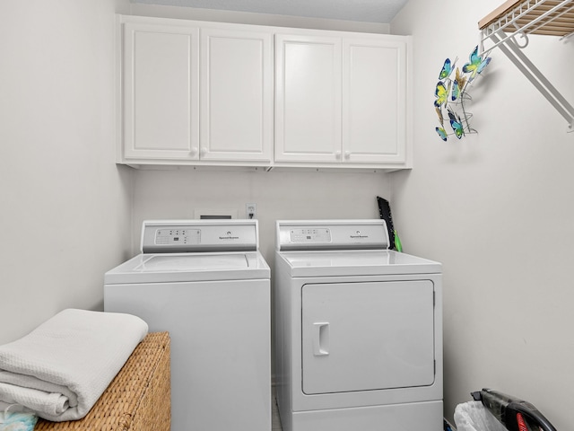laundry room with washing machine and dryer and cabinet space
