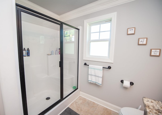 full bath featuring crown molding, tile patterned flooring, a stall shower, baseboards, and toilet