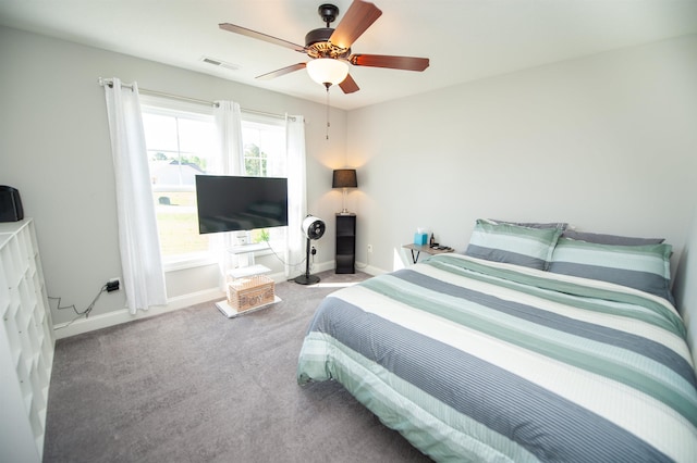carpeted bedroom with baseboards, ceiling fan, and visible vents