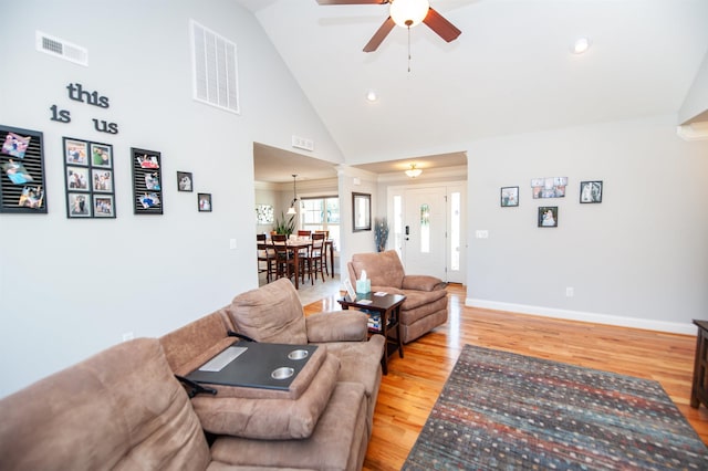 living room with a ceiling fan, baseboards, visible vents, and light wood-style flooring