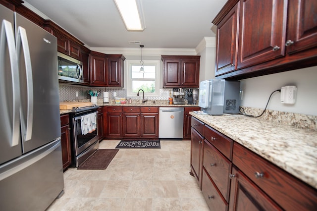 kitchen with crown molding, backsplash, appliances with stainless steel finishes, and a sink