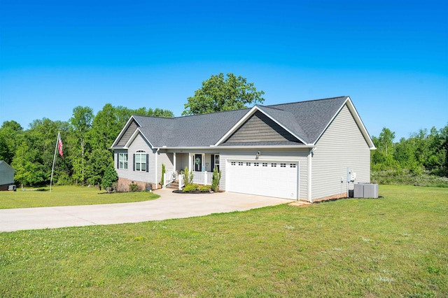 view of front of house with covered porch, an attached garage, driveway, and a front yard