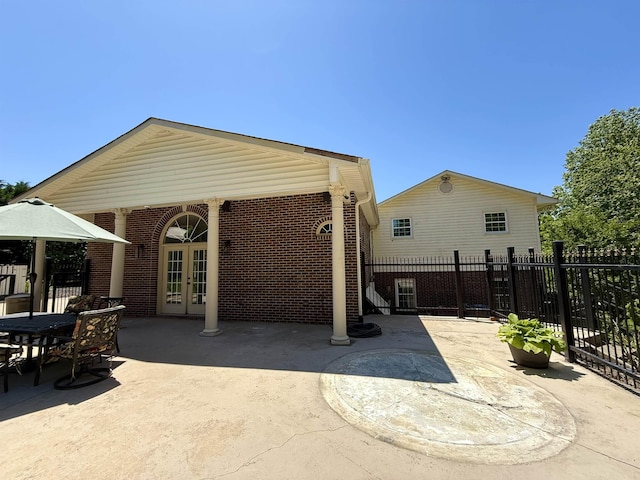 view of patio / terrace featuring french doors and fence